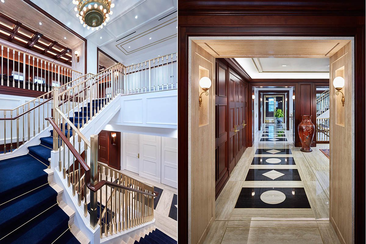 Elegant staircase with gold railings and crystal chandelier.