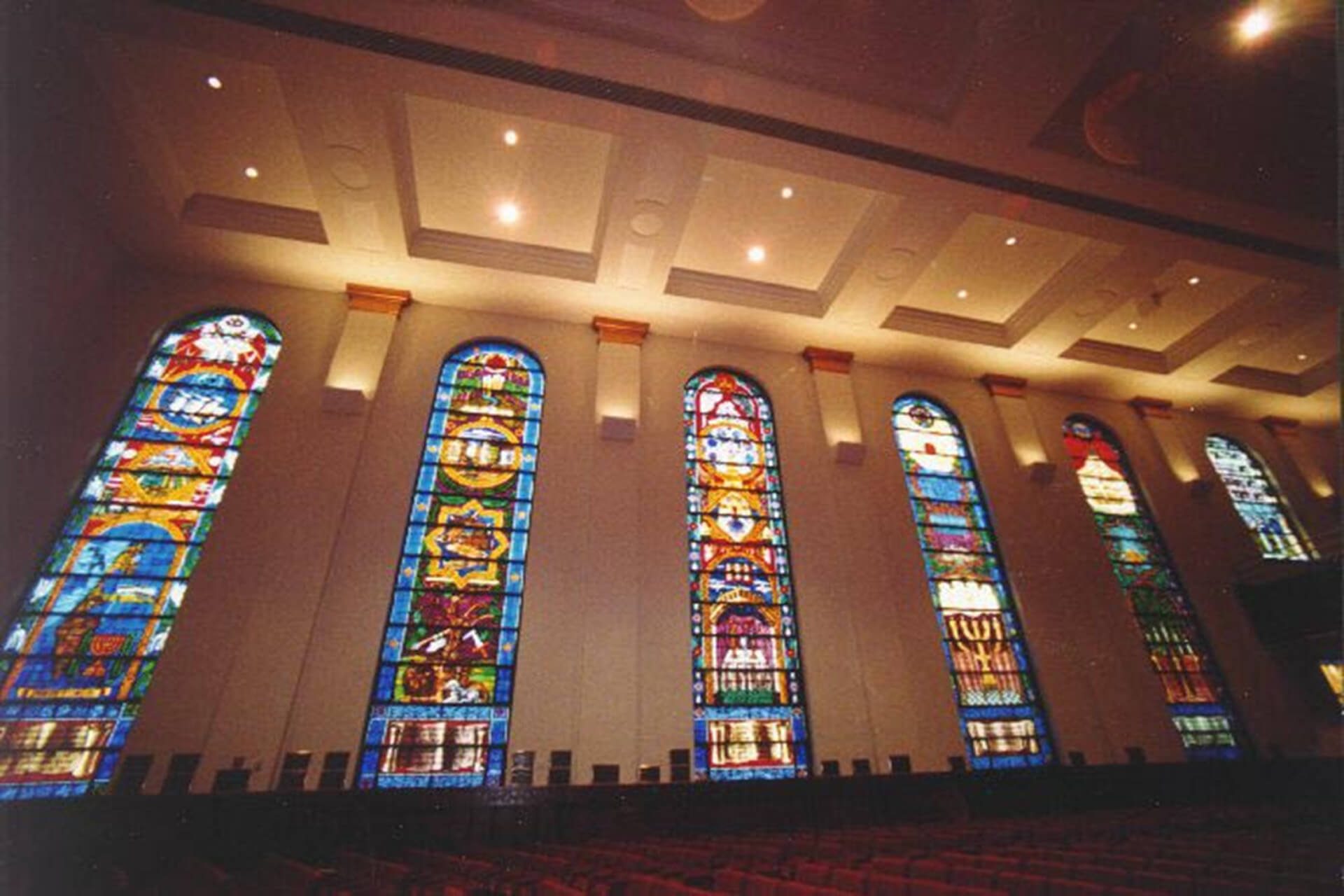 Colorful stained glass windows in a church interior.