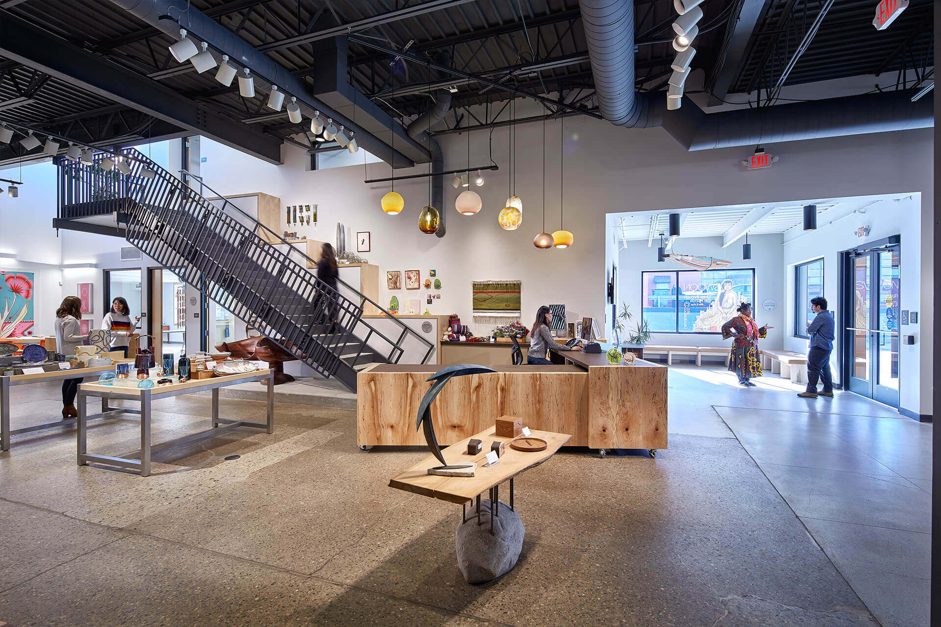 Modern interior of a well-lit retail space with wooden furniture and hanging lights.