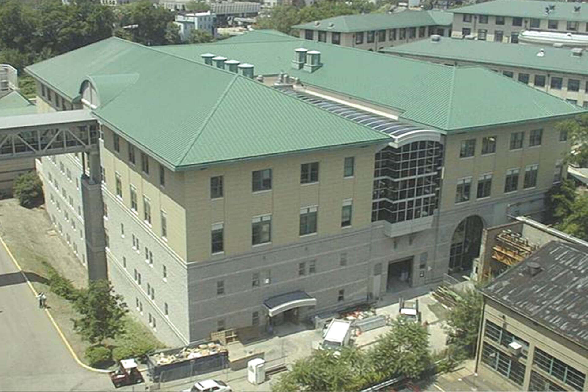 A large building with a green roof and multiple windows.
