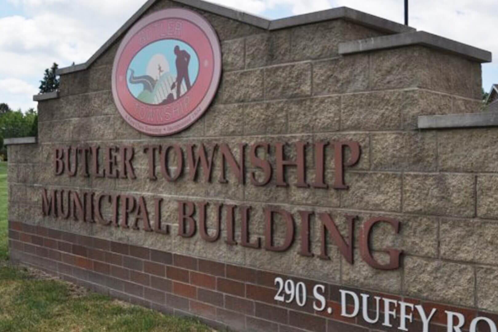 Sign for Butler Township Municipal Building on a stone wall.