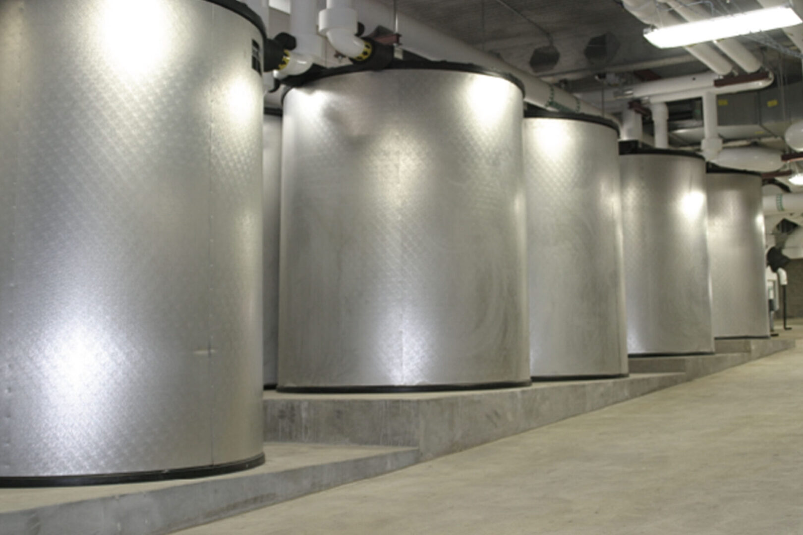 Large cylindrical metal tanks in an industrial setting.
