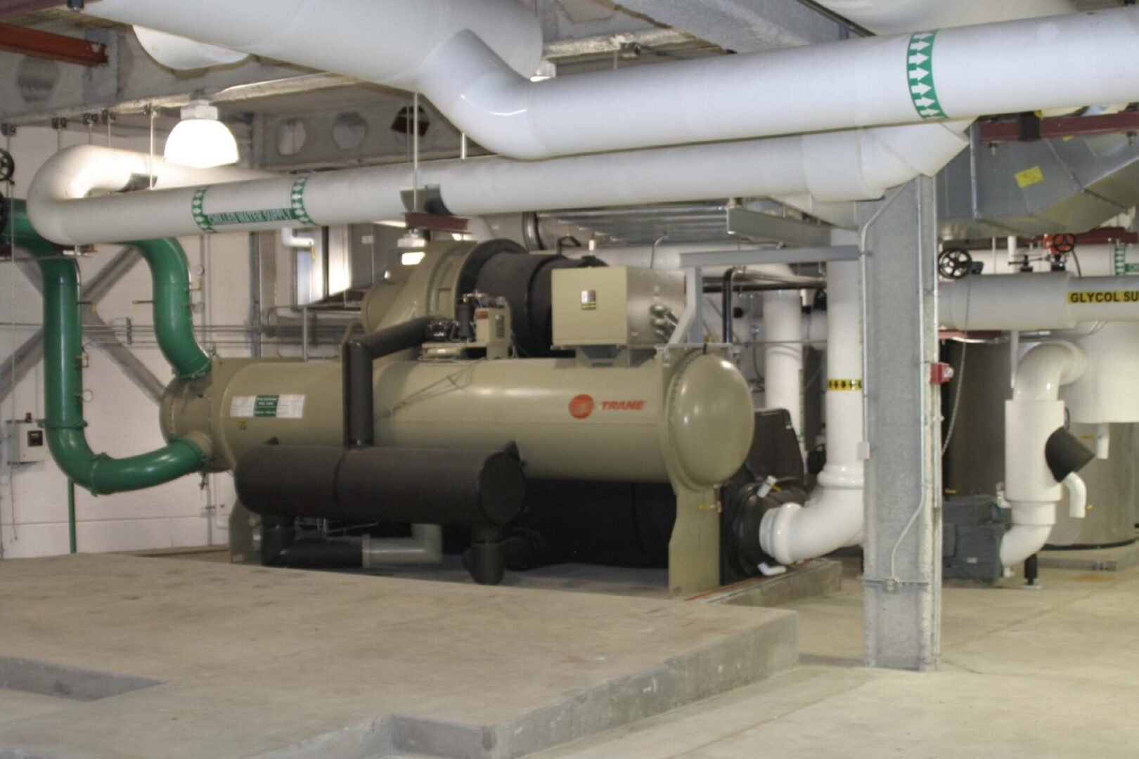 Industrial machinery and piping system in a factory setting.