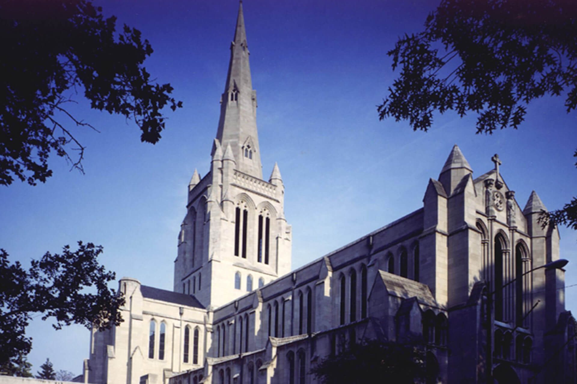 A tall church steeple against a clear blue sky.