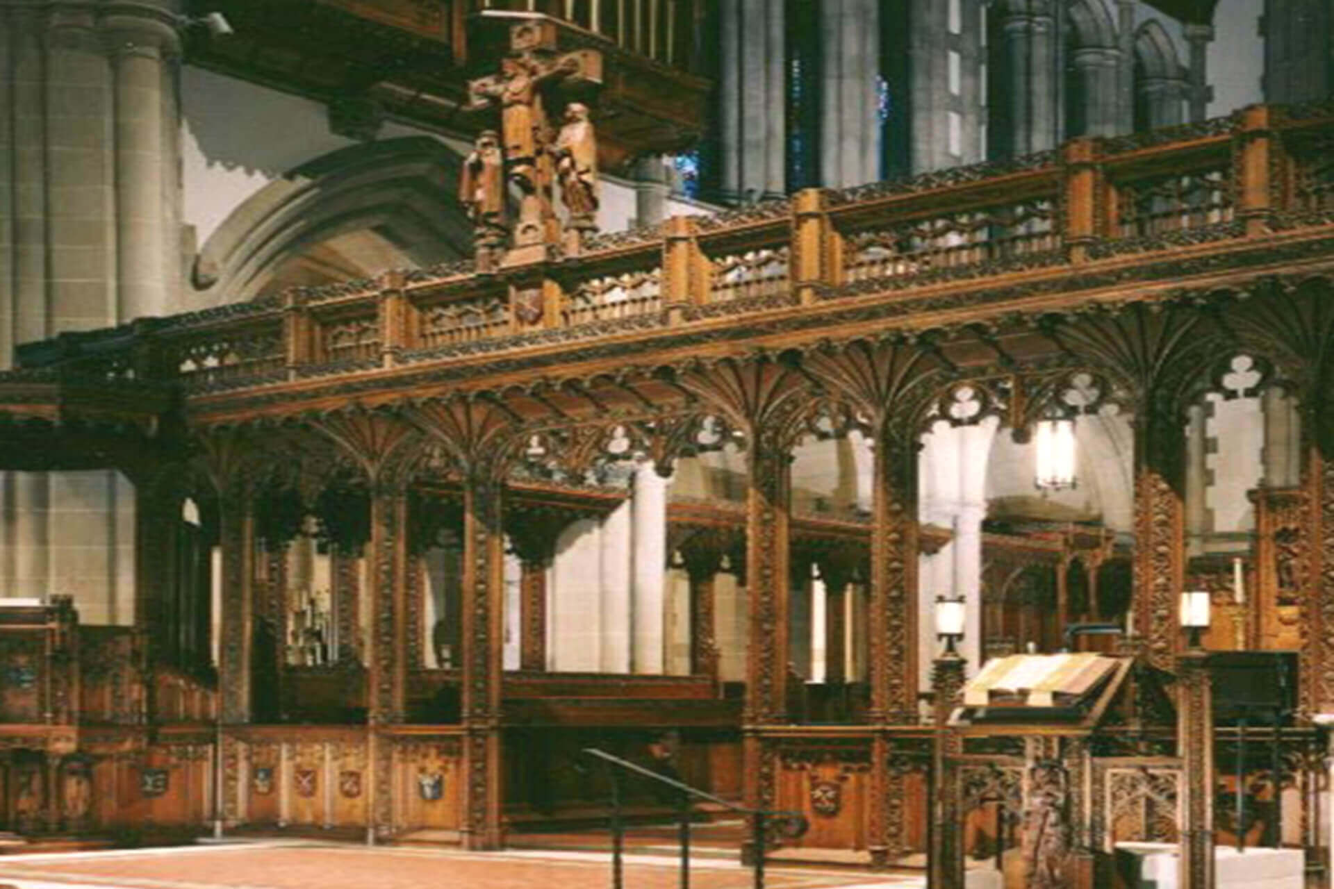 Ornate wooden choir stalls inside a historic church.