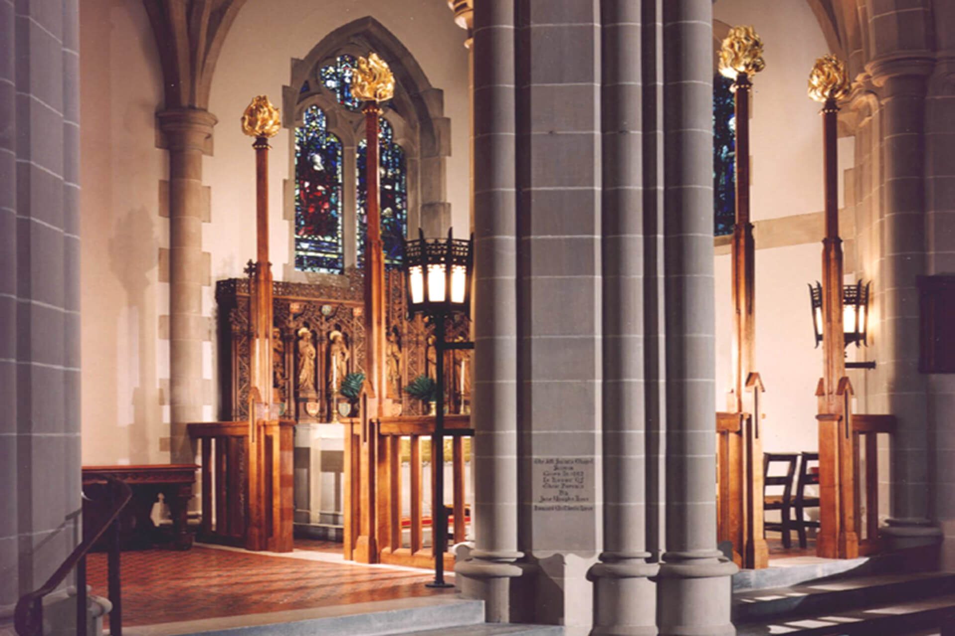 Interior of a church with stone pillars and wooden altar.