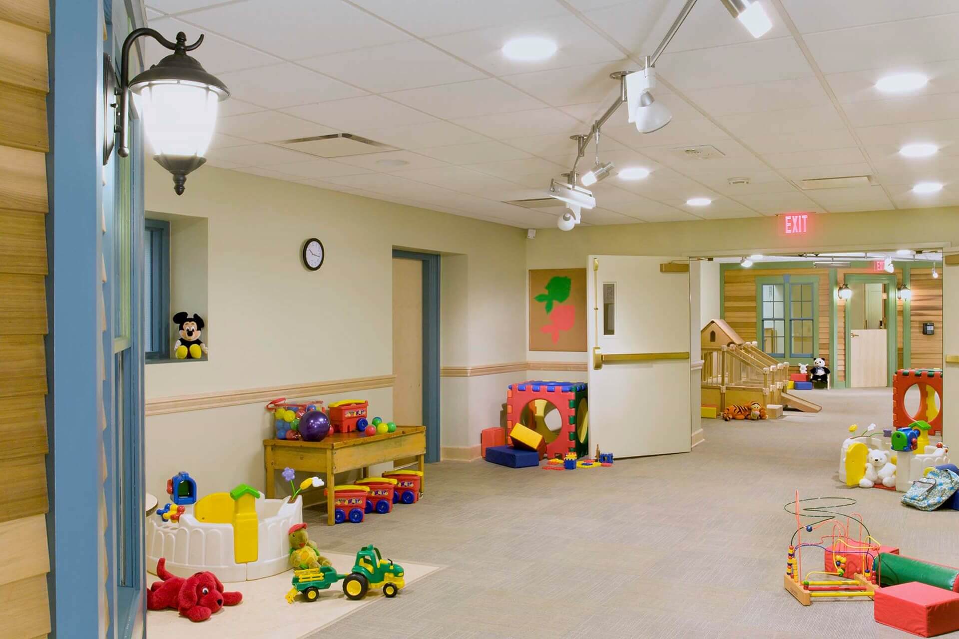 A colorful and spacious indoor playroom for children with toys and seating.