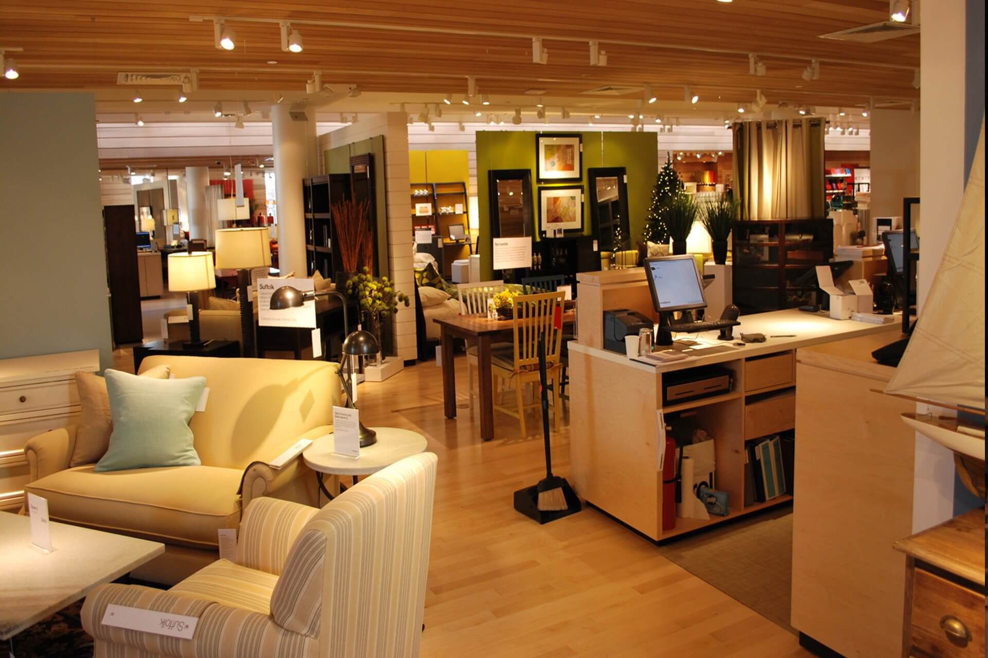 Interior view of a cozy furniture showroom with sofas and lamps.