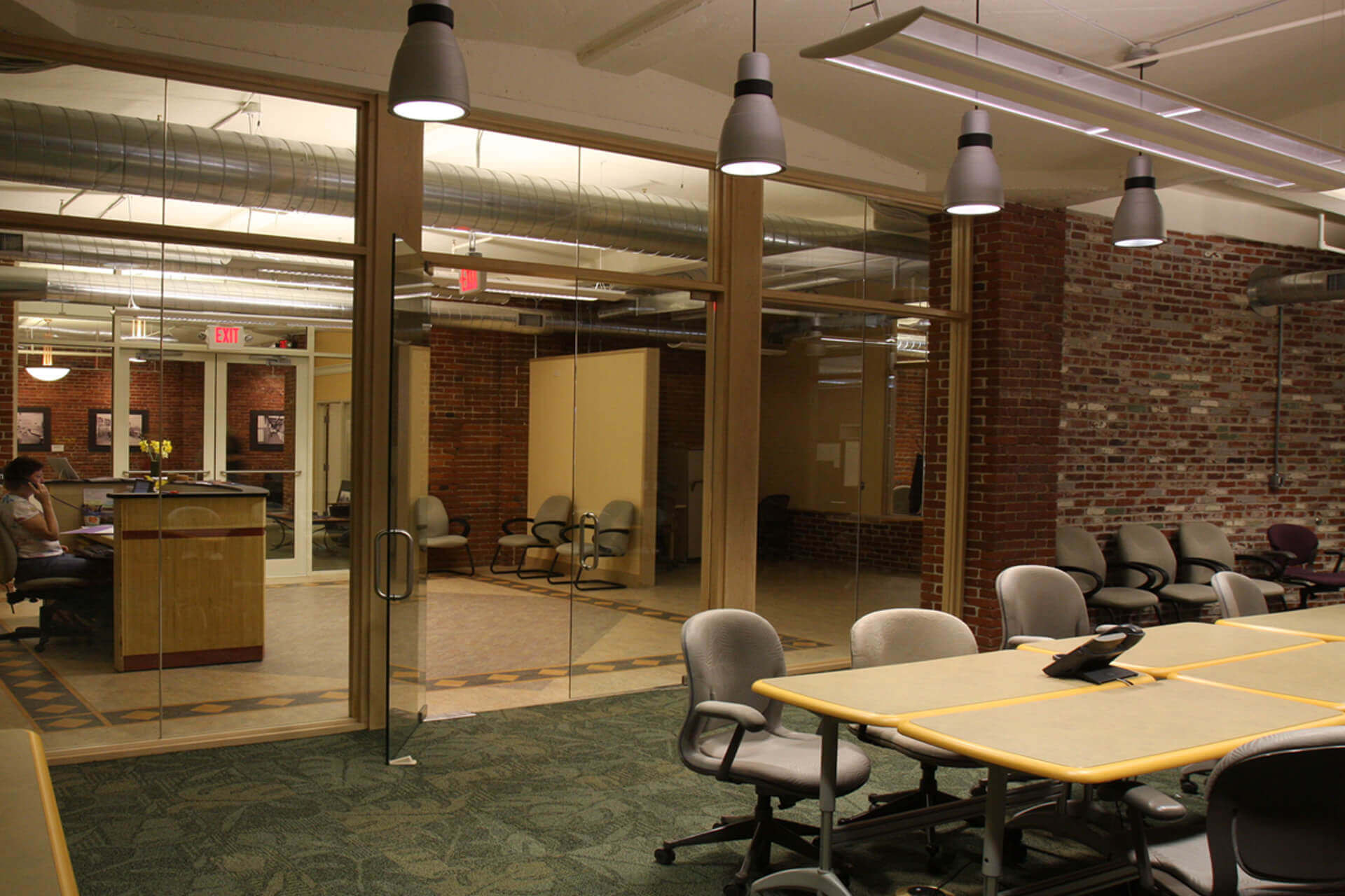 Modern conference room with chairs and glass walls.