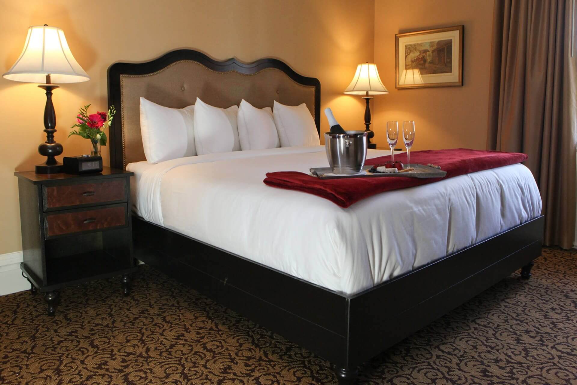 Luxurious hotel room with a king-sized bed and elegant decor.