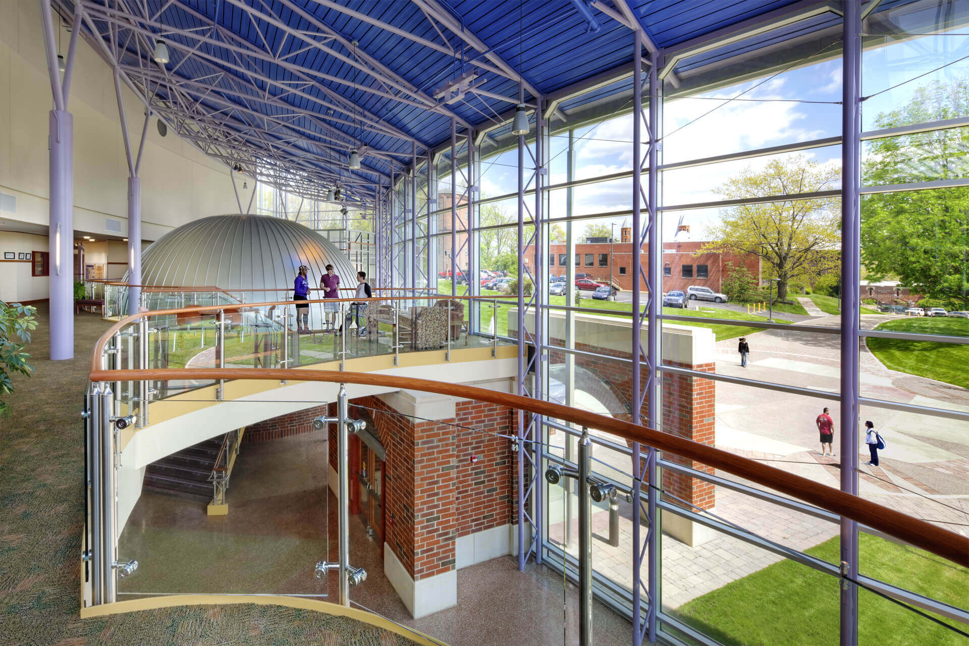 Modern indoor space with glass walls and a blue ceiling.