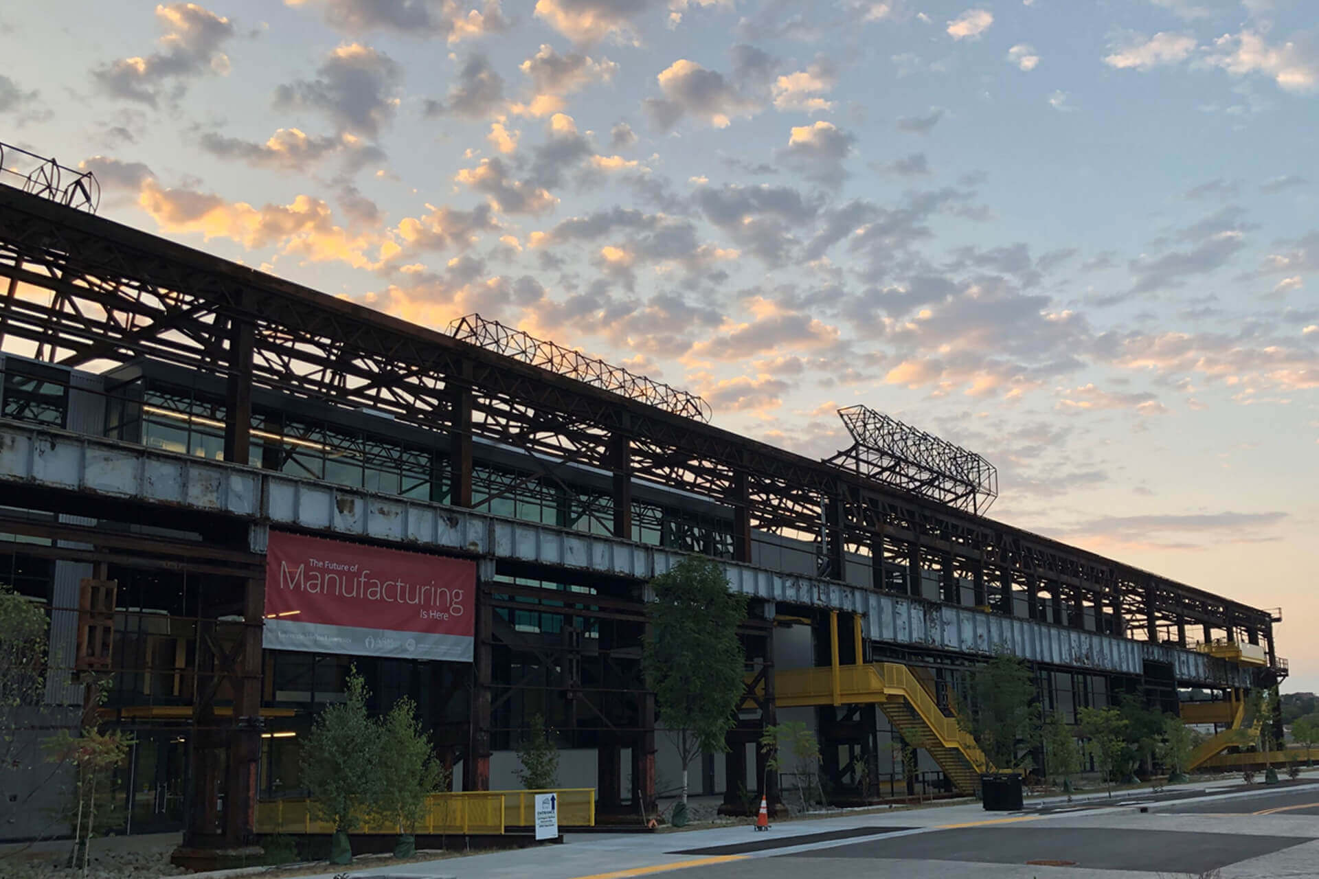 A building under a cloudy sunset sky.