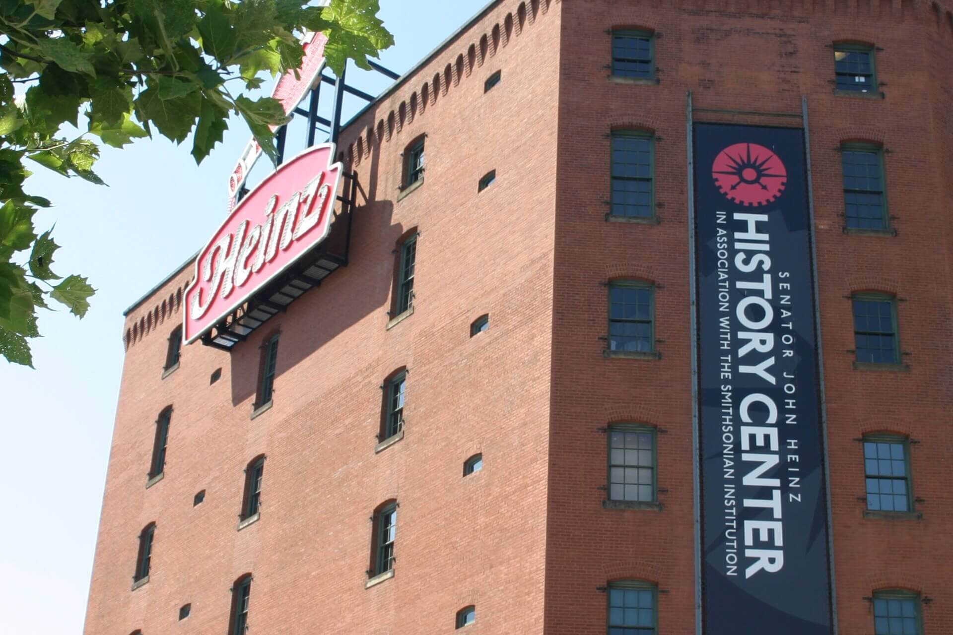 Historic brick building with Coca-Cola sign and History Center banner.