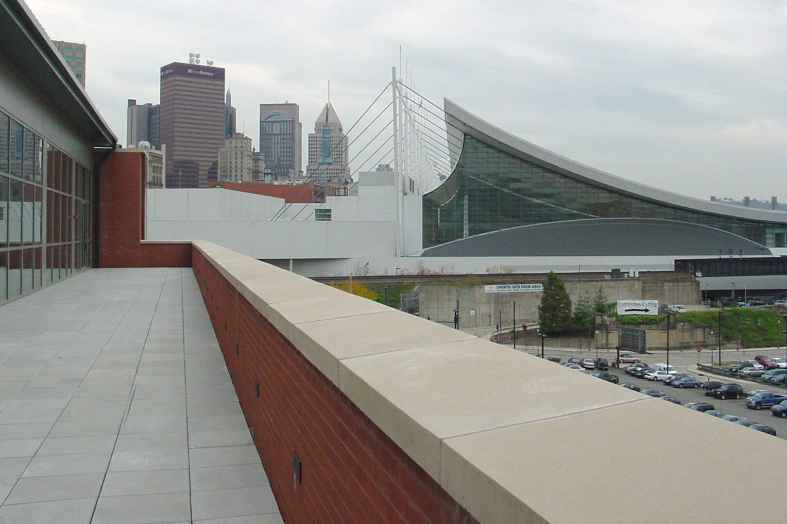 View of a city skyline with modern buildings and a unique architectural structure.