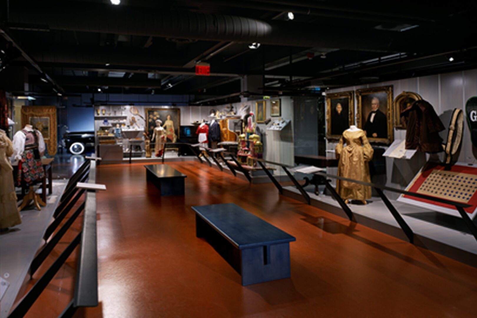 Museum exhibit showcasing historical clothing and artifacts.