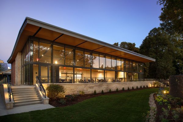 Contemporary glass-walled building lit at dusk