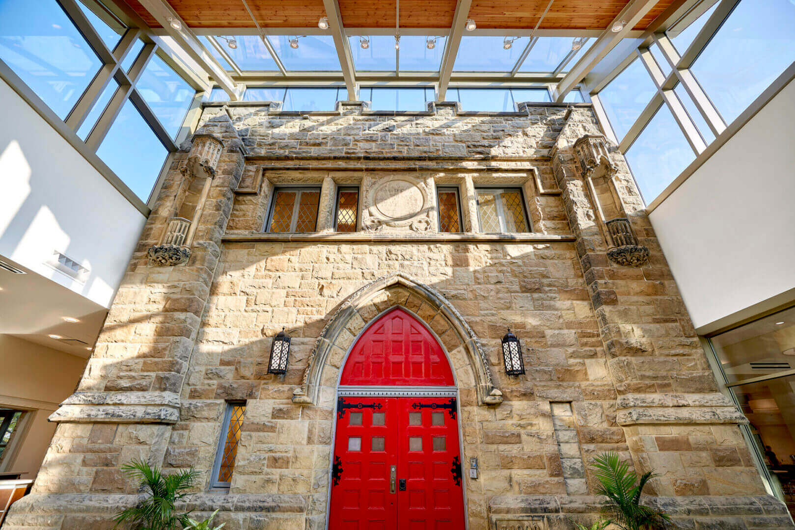 Stone facade with red arched door.