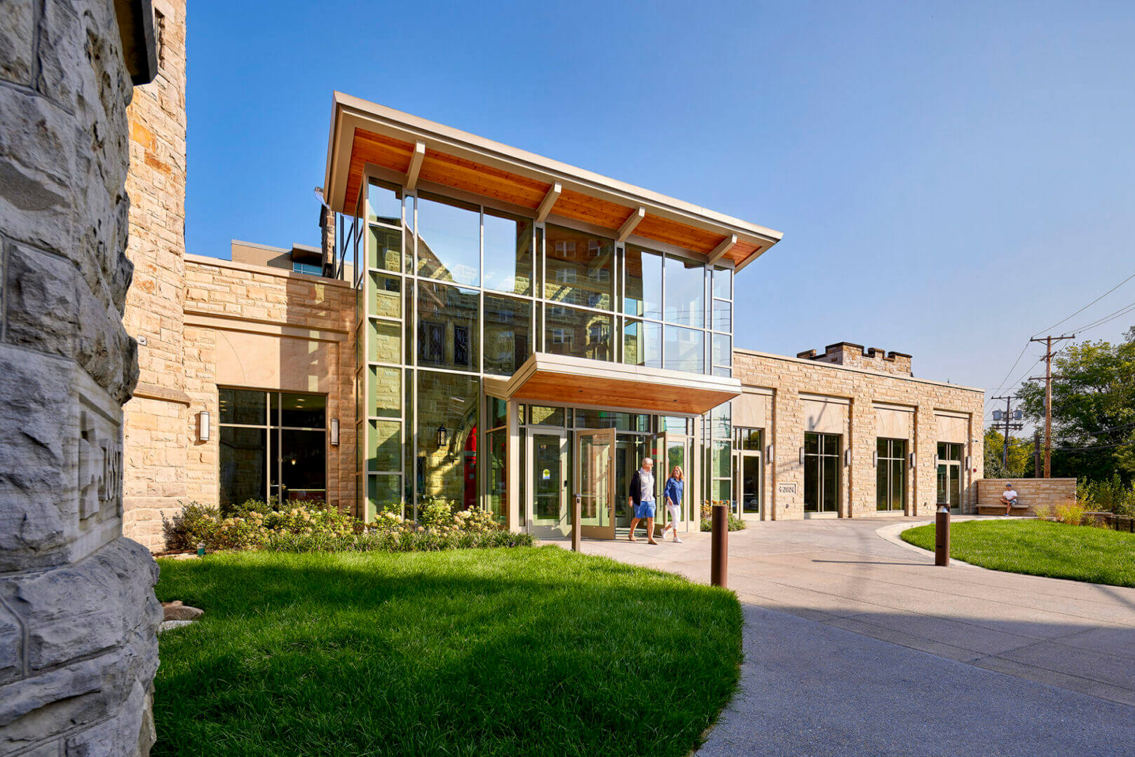 Modern building with glass entrance and walkway.