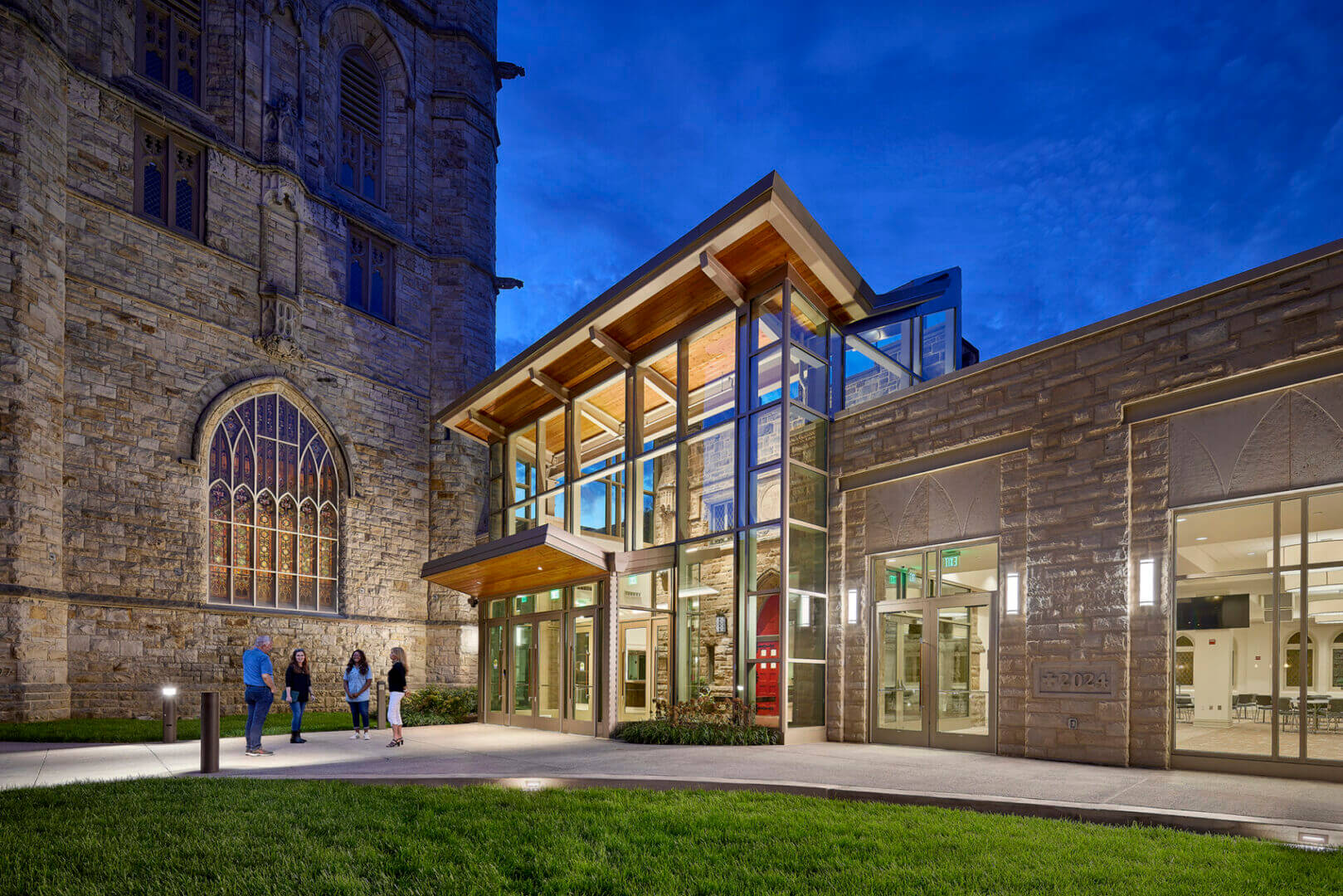 Modern building with illuminated glass entrance.