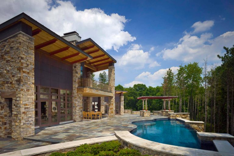 Stone house with pool and patio.