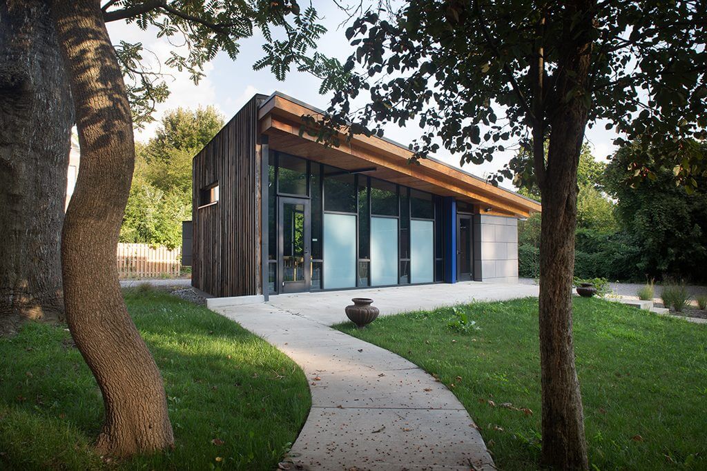 Modern house with slanted roof and garden.