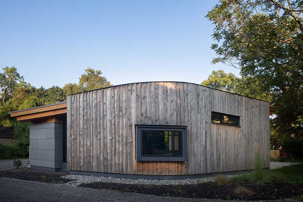 Modern wooden house with large window.