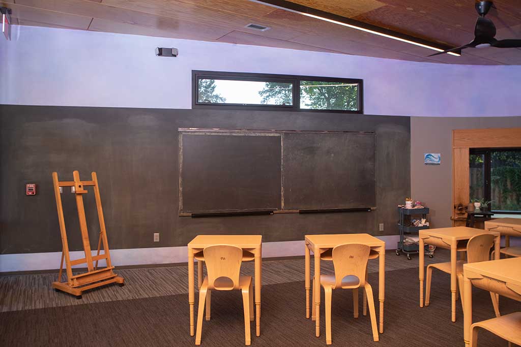 Classroom with chairs and blackboard.