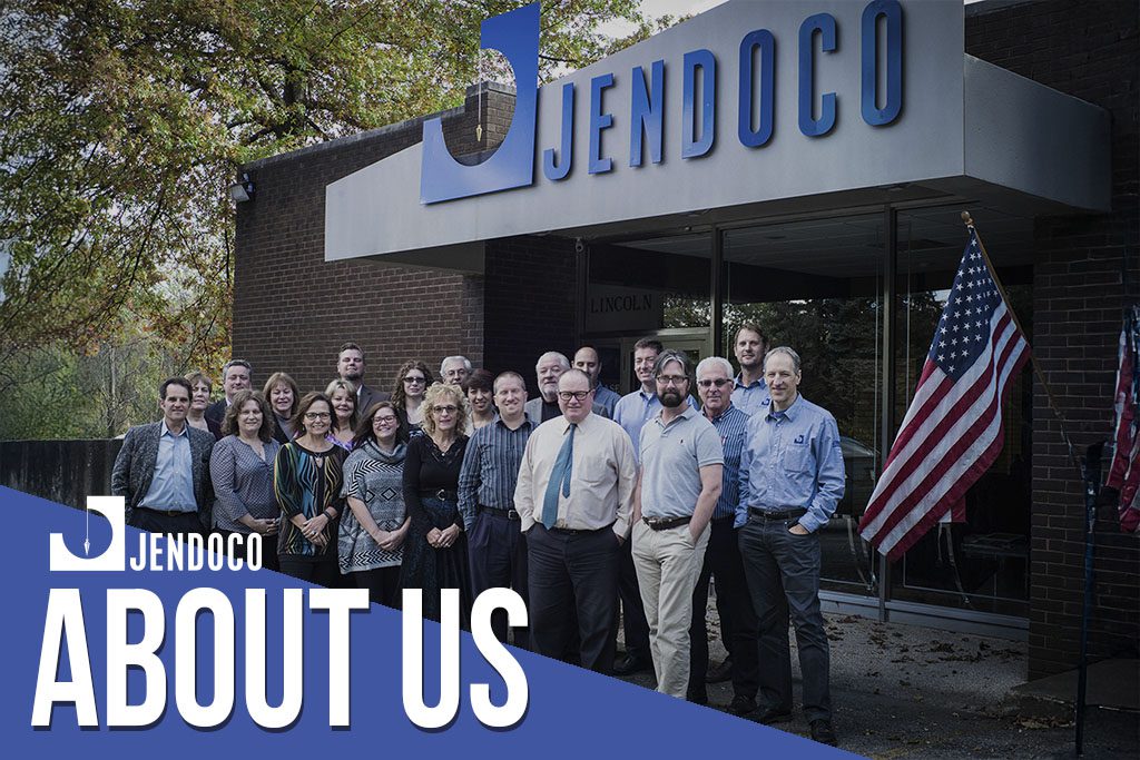 Jendoco team posing outside office building