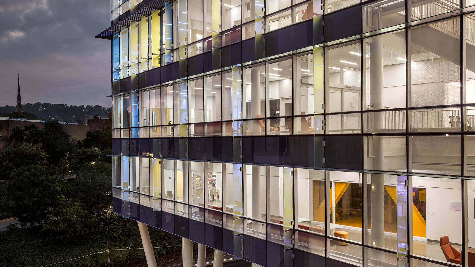 Multi-story glass office building at twilight