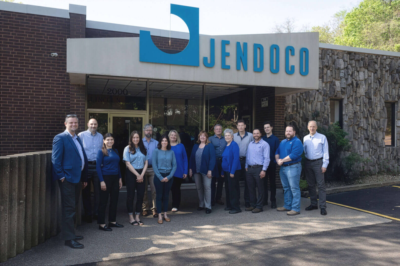 Jendoco team posing outside office building