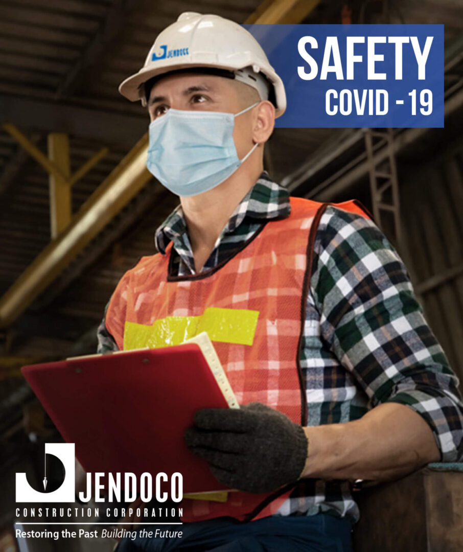 Masked construction worker in hard hat holding clipboard