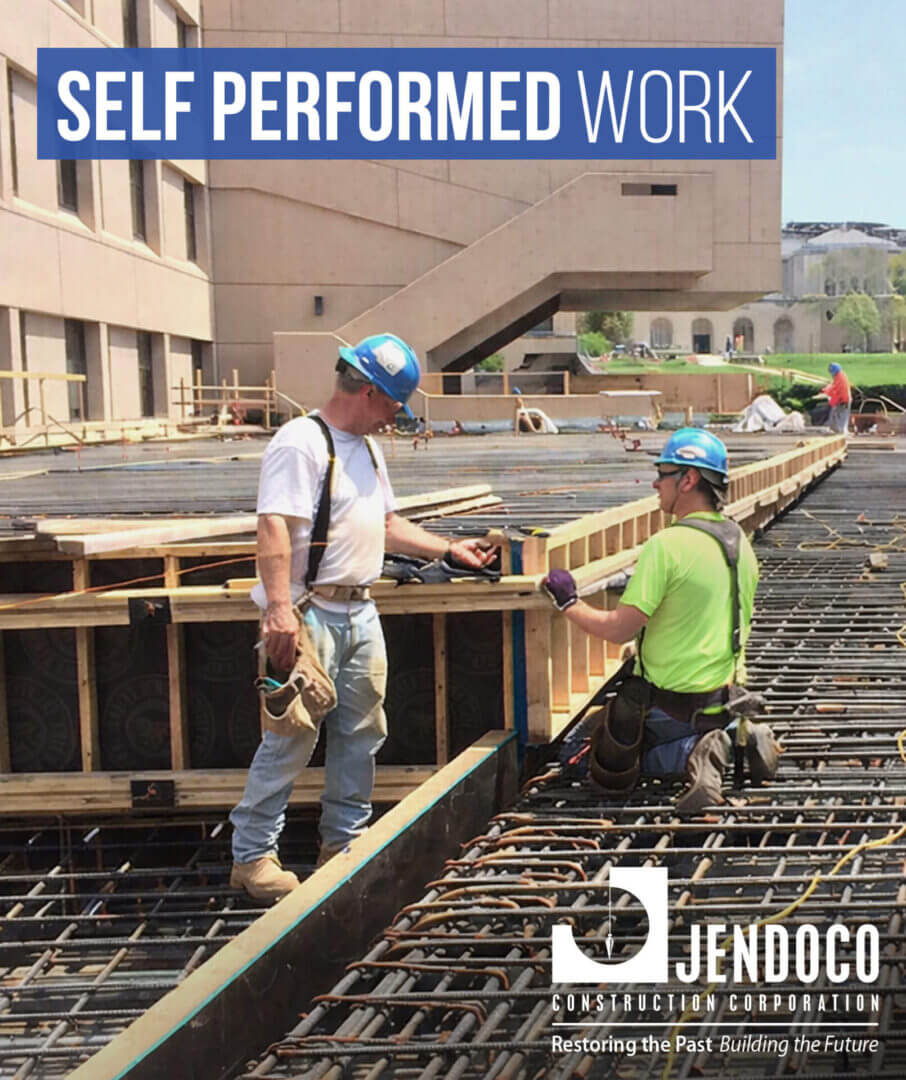 Construction workers installing rebar and formwork