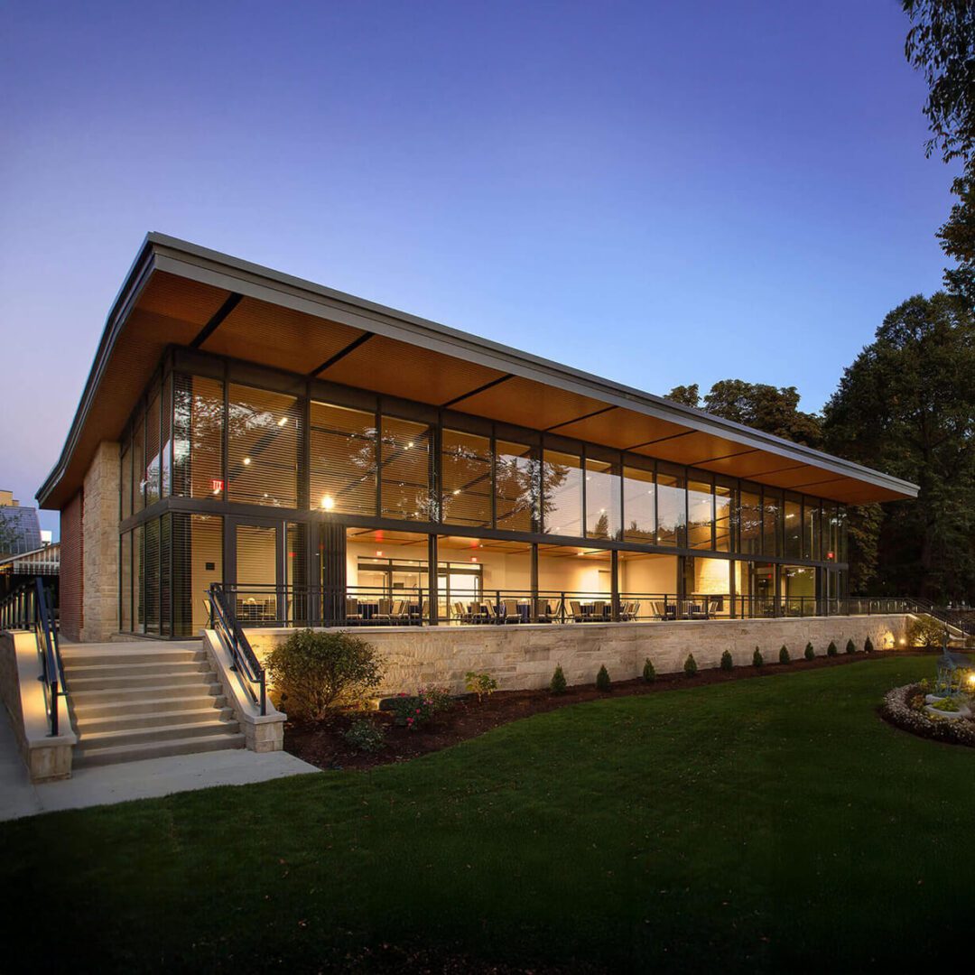 Modern glass-walled community center at dusk