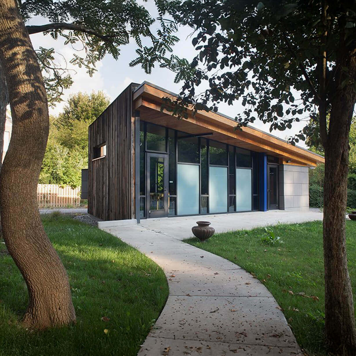 Modern wood-clad studio with curved pathway