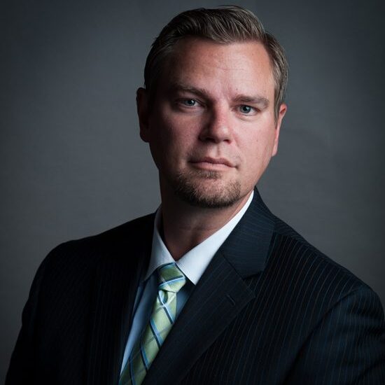 Man in suit with serious expression.