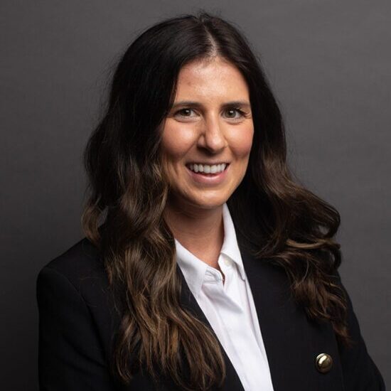 Smiling woman in business attire portrait.