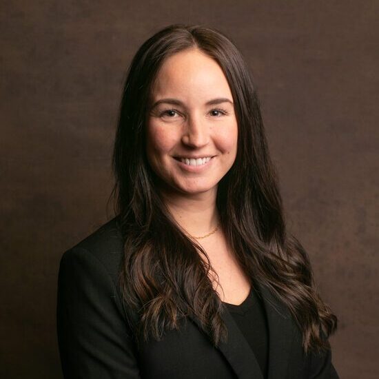 Smiling woman in professional attire portrait.