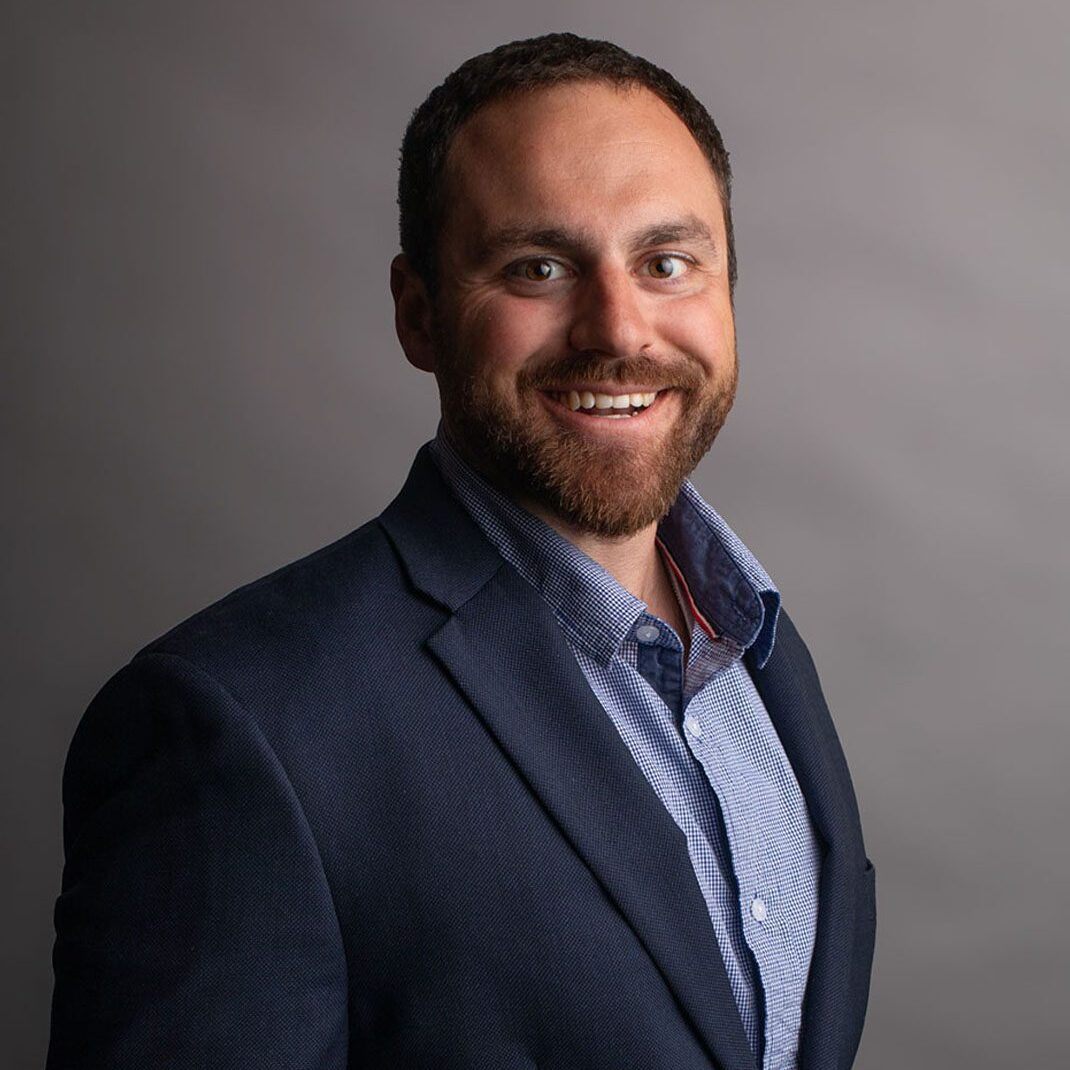 Smiling bearded man in navy blazer